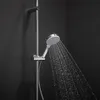 A close-up shot of a modern shower head with water spraying out, against a dark background. Podgląd zdjęcia produktu