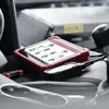 A diagnostic tablet and its cable are placed on the leather seat of a car. Produktbild-Vorschau