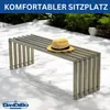 A modern metal bench with a straw hat on it, placed on a white patio with shadows from trees. Produktbild-Vorschau
