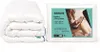A folded white duvet is shown next to its packaging, which features a lifestyle image of a woman reading in bed. Produktbild-Vorschau