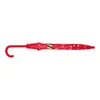 A closed red umbrella with white polka dots and a red handle, lying horizontally against a white background. Produktbild-Vorschau