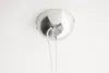 A close-up view of a ceiling light fixture's canopy and wires. Produktbild-Vorschau