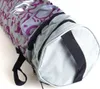 A close-up shot of a cylindrical storage bag with a purple monkey pattern. Produktbild-Vorschau