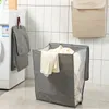 A laundry room scene with a washing machine, a hanging laundry bag, and a laundry basket filled with clothes. Produktbild-Vorschau