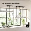 Hanging planters with plants displayed in a window setting. Podgląd zdjęcia produktu