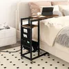 A C-shaped side table with a laptop and a drink on it, placed next to a bed. Produktbild-Vorschau