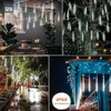 Collage of images showing white meteor shower rain lights used for outdoor decoration in various settings, including a patio, trees, and under an eave. Náhľad obrázku produktu