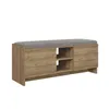 A long, low bench with a gray upholstered top and a wood-grain finish on the body. The body has two cabinet doors on the sides and two open shelves in the center. Produktbild-Vorschau
