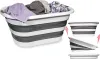 A collapsible laundry basket filled with clothes, shown from the side. Smaller images on the right show the basket in a collapsed state. Voir les images du produit