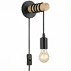 A wall-mounted light fixture with a wooden bar and a black pendant light. Produktbild-Vorschau