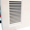 A close-up view of the side of a white electric heater, showing a ventilation grille. Produktbild-Vorschau