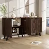 A dark wood sideboard with a textured door front, set against a textured wall and next to a window with blinds. Produktbild-Vorschau