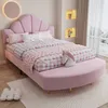 A pink upholstered bed with a seashell-shaped headboard and a matching bench in a child's bedroom. Produktbild-Vorschau