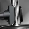 A close-up of a black and silver car mount attached to a metal pole. Voir les images du produit