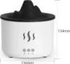 A white aroma diffuser with a black mountain-like top and flame-shaped cutouts on the side. Dimensions are shown with text overlays. Náhľad obrázku produktu