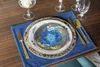 A table setting with plates, cutlery, and glasses on a wooden table. Podgląd zdjęcia produktu