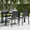An outdoor dining set with a black table and chairs on a paved patio, surrounded by greenery. Produktbild-Vorschau