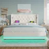 A bedroom scene featuring a white upholstered bed with LED lighting. Voir les images du produit