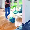 A person is using a spin mop and bucket on a wooden floor. Anteprima dell’immagine prodotto