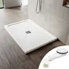 A white shower tray with a drain is shown on a wooden floor next to a tiled wall. A separate image of a drain assembly is in the bottom right corner. Anteprima dell’immagine prodotto