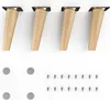 Four wooden furniture legs with metal mounting plates and a collection of screws and felt pads. Produktbild-Vorschau