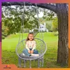 A young girl sits in a hanging chair in a garden with a house in the background. Voir les images du produit