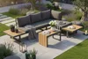 A modern outdoor lounge set on a patio with surrounding garden. Produktbild-Vorschau