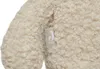 A close-up of a teddy bear's fur with a brand tag. Produktbild-Vorschau