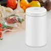 A white vacuum sealer sits on a table next to vacuum-sealed food items and fresh produce. Produktbild-Vorschau