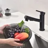 A black kitchen faucet is shown rinsing a bowl of fruit under running water. Produktbild-Vorschau