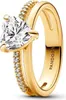 A close-up studio shot of a gold Pandora ring with a heart-shaped clear stone and small clear stones along the band. Produktbild-Vorschau