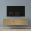 A wall-mounted television and media console in a room with a blue wall and wooden floor. Produktbild-Vorschau