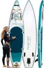 A woman in a wetsuit stands next to two inflatable stand-up paddleboards. Náhled obrázku produktu