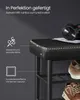 A close-up of a black shoe bench with a leather seat and metal frame, showcasing its stitching and texture. Shoes are visible on the lower shelves. Produktbild-Vorschau