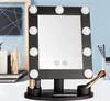 A makeup mirror with LED lights is displayed on a desk with various accessories. Produktbild-Vorschau