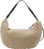 A fluffy taupe crossbody bag with black leather straps against a white background. Produktbild-Vorschau