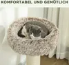 A cat is sleeping in a fluffy cat bed on a cat tree. Náhled obrázku produktu