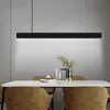 A modern dining room with a table set for a meal, illuminated by a sleek black pendant light. Anteprima dell’immagine prodotto