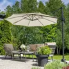 An outdoor patio set with a large cantilever umbrella providing shade over a sofa, chairs, and coffee table. Náhľad obrázku produktu