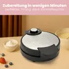 A waffle maker with accompanying ingredients and batter bowl on a table. Náhľad obrázku produktu