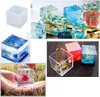 A collage of images showing various resin casting molds and finished resin products, including cubes with embedded objects like shells and flowers, and a hand holding a resin cube with a rose inside. Produktbild-Vorschau