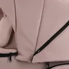A close-up view of the fabric and zipper details of a beige baby stroller. Produktbild-Vorschau