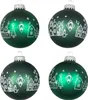 Four green Christmas ornaments with white festive designs. Produktbild-Vorschau