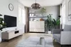 A modern living room with a TV, entertainment center, sofa, and coffee table. Produktbild-Vorschau