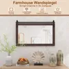 A farmhouse-style wall mirror with a dark brown wooden frame, displayed above a console table with decorative items. Podgląd zdjęcia produktu