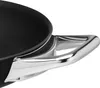 A close-up view of the handle and rim of a black frying pan. Produktbild-Vorschau