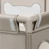 A close-up view of the corner of a beige playpen, showing the connection of the poles and fabric. Produktbild-Vorschau