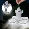A hand holding a solar-powered lantern in a forest setting at night. Anteprima dell’immagine prodotto