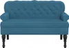 A studio shot of a blue velvet loveseat. Náhled obrázku produktu