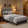 A bedroom scene with a bed, nightstands, and artwork. Náhled obrázku produktu